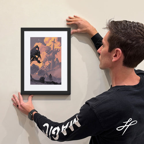 Jake Hartigan Holding a framed limited edition print of "Bravery" from the collection Conquer Fear