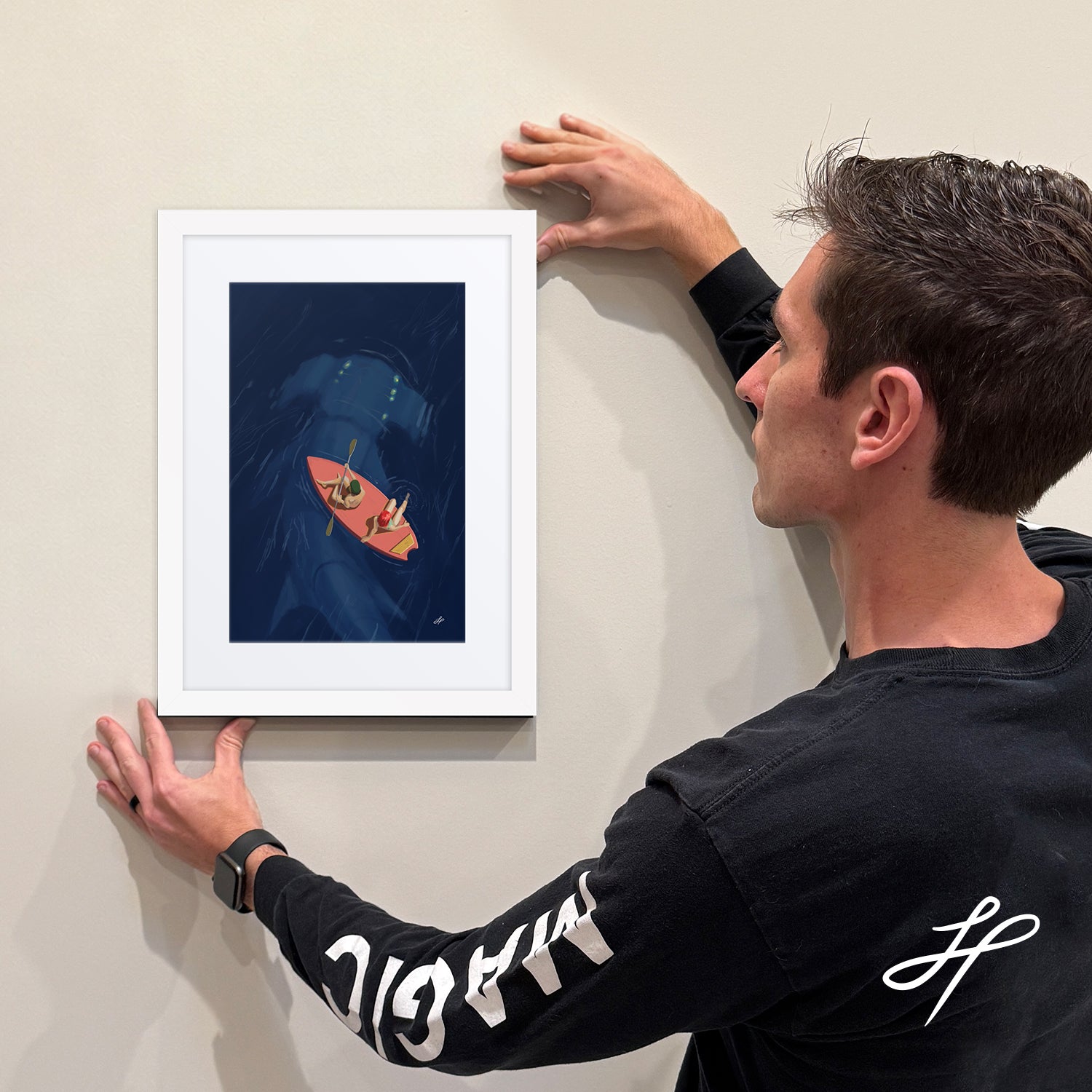 Jake Hartigan holding an example of the limited edition framed print "Curiosity" 