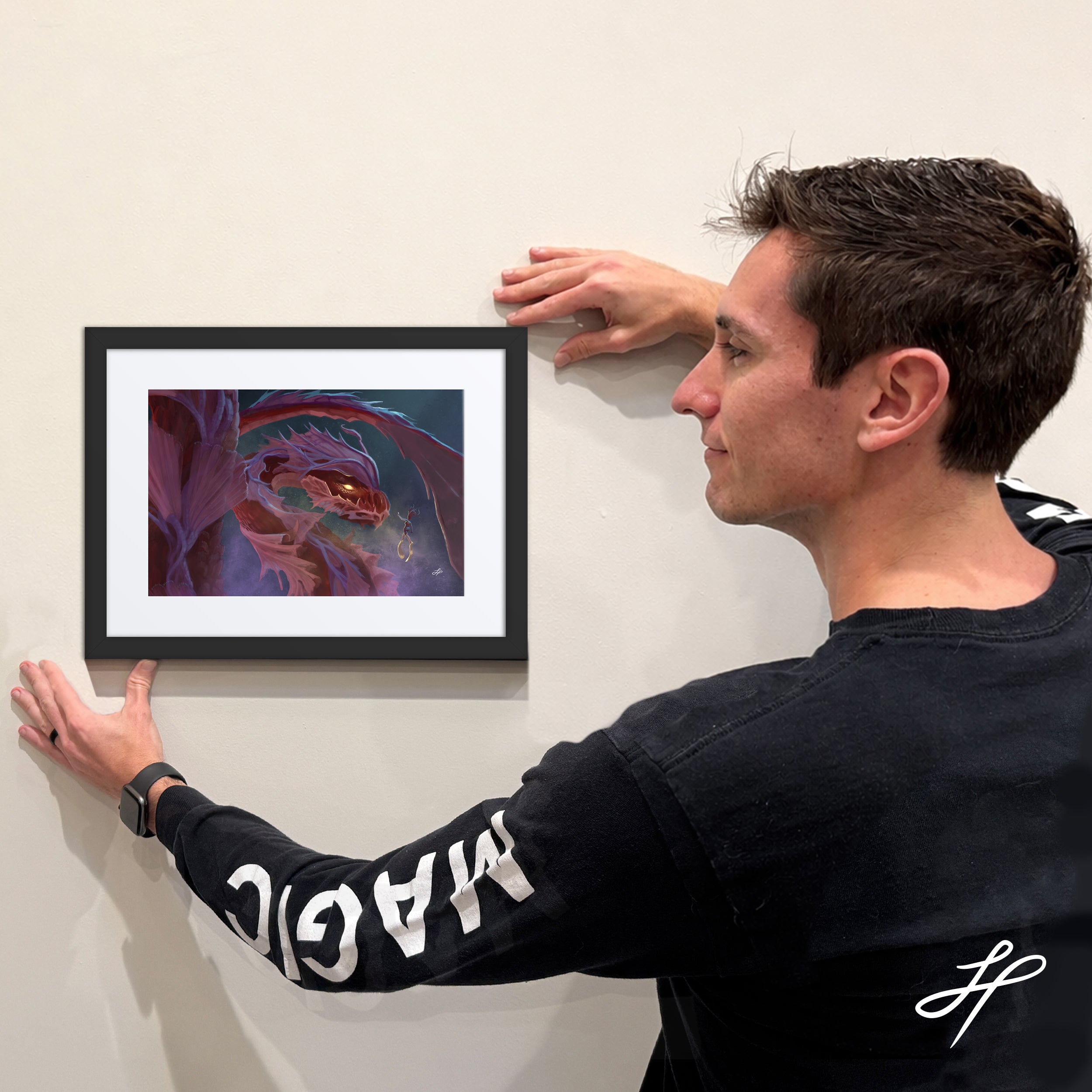 Jake Hartigan holding a limited edition framed print of "Swimming"